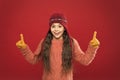Look here. Little girl winter fashion accessory. Small child wear hat burgundy background. Cute model enjoy winter style