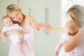 Look how cute you are. A cute baby girl looking at herself in the mirror while her mom points. Royalty Free Stock Photo