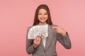 Look, I am rich! Portrait of wealthy elegant businesswoman in suit jacket holding dollar banknotes