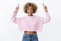 Look I show you. Friendly-looking outgoing joyful attractive dark-skinned woman with fair curly haircut raising hands Royalty Free Stock Photo