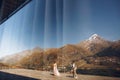 Look from inside at bride and groom walking on the terasse Royalty Free Stock Photo