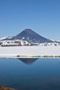 Look at Karymsky volcano from the hot springs and geyser Karymsky lake