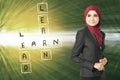 Look at Learn, lead and earn word box on her left over abstract background Royalty Free Stock Photo