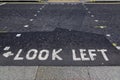 Look left written on the pavement at the pedestrian or puffin crossing in central London, England Royalty Free Stock Photo