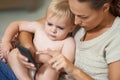 Look at this.... A mother showing her baby boy something on her cellphone. Royalty Free Stock Photo