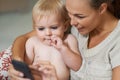 Look at this...A mother showing her baby boy something on her cellphone. Royalty Free Stock Photo