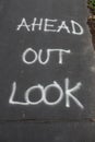 LOOK OUT AHEAD in Spray Paint on Asphalt