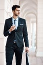 Look the part, be the part. a young handsome businessman using a cellphone outside.