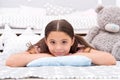 Look of perfection. Little girl with cute look. Beauty look of skincare model. Small child relax on bed in nursery