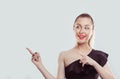 Look right here on my right. Portrait of young beautiful woman pointing fingers up to side at empty copy space Standing happy Royalty Free Stock Photo