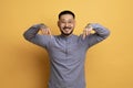 Look At This. Smiling Asian Guy Pointing Down With Two Hands Royalty Free Stock Photo