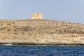 Look on St. Mary`s Tower from the sea. Malta, Gozo, Comino. Royalty Free Stock Photo
