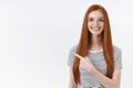 Look there hurry up catch promo. Charming lively attractive redhead girl smiling pleasantly pointing upper left corner