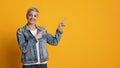 Look There. Positive Middle-Aged Woman Pointing Fingers Aside At Copy Space Royalty Free Stock Photo