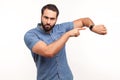 Look at time! Impatient bossy man with beard pointing finger at wrist watch and looking annoyed and displeased, showing clock to Royalty Free Stock Photo