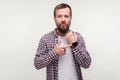 Look at the time! Portrait of serious bearded man standing pointing at wristwatch meaning time to go. white background Royalty Free Stock Photo