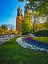 Look to small colorful garden in front of Basilica of Saint Peter and Paul in Poznan City at sunny morning Royalty Free Stock Photo