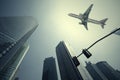 Look up at aircraft is flying modern urban office buildings in S Royalty Free Stock Photo