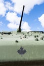 Look up view of a Canadian armoured personnel carrier with the Canadian military emblem and