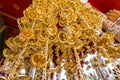 Look up view of of many small golden bells was hung in a group in Thai temple. Royalty Free Stock Photo