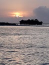 when the sun sets over the watervilla resort with its beautiful nature on the Maldives beach