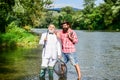 Look what we caught. retired father and mature son with beard. Fly fishing adventures. happy fishermen in water. friends Royalty Free Stock Photo