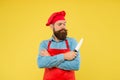 Look what cook. chef in restaurant kitchen. mature male chef on yellow backdrop. serious man cooking on kitchen