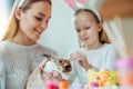 Look what a cute rabbit!The little daughter with her mother stroke a home decorative rabbit