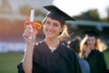 Look at what hard work earned me. Portrait of a university student standing amongst her classmates on graduation day. Royalty Free Stock Photo