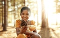 Look what I just found. Portrait of an adorable little girl playing in the woods. Royalty Free Stock Photo