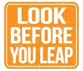 LOOK BEFORE YOU LEAP, text written on orange stamp sign Royalty Free Stock Photo
