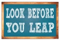 LOOK BEFORE YOU LEAP words on blue wooden frame school blackboard