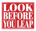 LOOK BEFORE YOU LEAP, text on red stamp sign Royalty Free Stock Photo