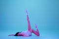 Young and graceful ballet dancer isolated on blue studio background in neon light. Art, motion, action, flexibility Royalty Free Stock Photo