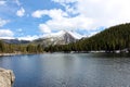 Looking across Bear Lake to the pine covered mountain slope and snow covered mountain peaks on the other side Royalty Free Stock Photo