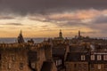 Looking across the Edinburgh rooftops as the sun sets on a cloudy day in Scotland