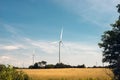 A wind turbine farm in a rural field