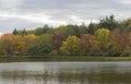 Looking across a lakein early autumn as the trees change colour