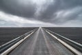 Looking across the long Skeidararsandur bridge with a storm on the horizon in Iceland