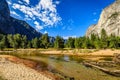 Looking across the Merced river down the Yosemite Valley towards the swinging bridge Royalty Free Stock Photo