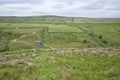 Looking across to old stone barns on Stonesdale Moor, near Keld, Swaledale, Yorkshire Dales, England. Royalty Free Stock Photo