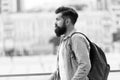 Looking for adventures. Tourist handsome thoughtful hipster backpack. Man with beard and rucksack explore city Royalty Free Stock Photo