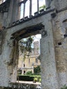 Looking through ancient ruin at castle and garden courtyard