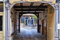 Looking through arched doors in an old building to a shop in the back yard Royalty Free Stock Photo