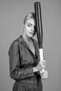 looking away. rounders game. woman in boilersuit with bat. female baseball player