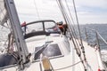 Looking back from the stern at a sailboat with brown dog.