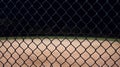 Looking at a baseball field at night through the fence. Royalty Free Stock Photo
