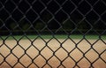 Looking at a baseball field at night through the fence. Royalty Free Stock Photo