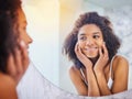 Looking beautiful, beautiful. an attractive young woman admiring her face in the bathroom mirror. Royalty Free Stock Photo