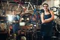 Looking for the bike expert Youve found her. Portrait of a young woman working in a bicycle repair shop with her